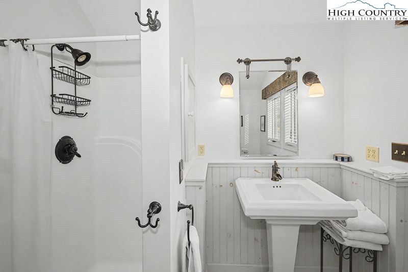 137 Granny's Ridge Road Ferguson, NC 28624 - Photo 18 of 27 a bathroom with a sink and mirror