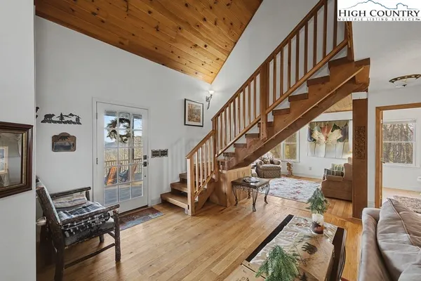 a view of entryway livingroom and hall with wooden floor