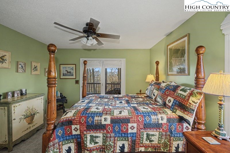 137 Granny's Ridge Road Ferguson, NC 28624 - Photo 21 of 27 a bedroom with a bed and a mirror