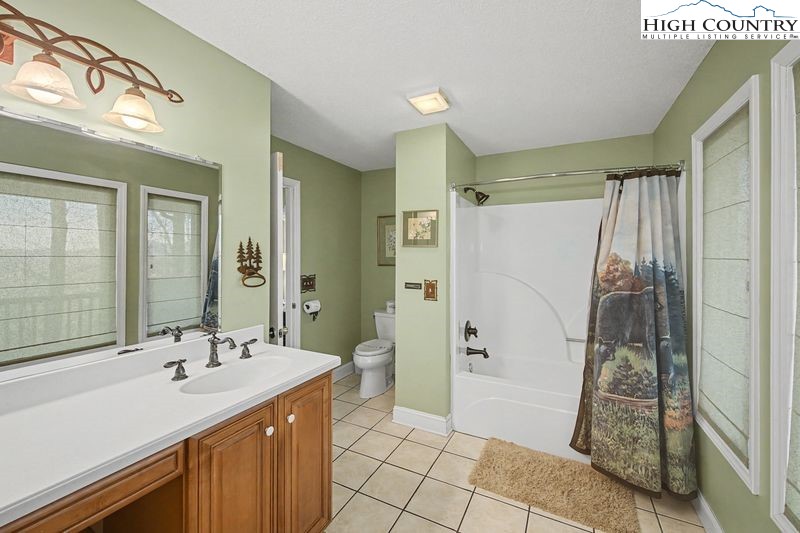 137 Granny's Ridge Road Ferguson, NC 28624 - Photo 22 of 27 a bathroom with a sink a mirror and a shower