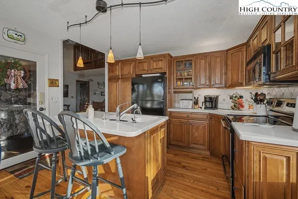 a kitchen with granite countertop a sink a counter top space stainless steel appliances and cabinets