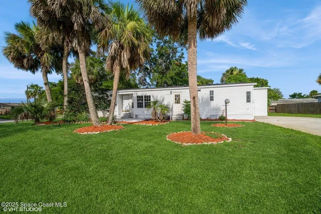 a view of a house with a swimming pool and a yard
