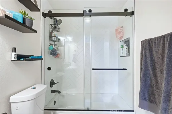 a bathroom with a shower and a toilet