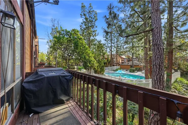 a view of balcony with wooden floor and fence