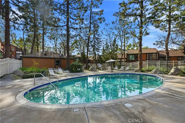 a swimming pool with outdoor seating and yard