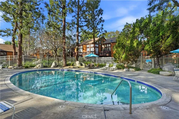 a view of swimming pool with outdoor seating and plants