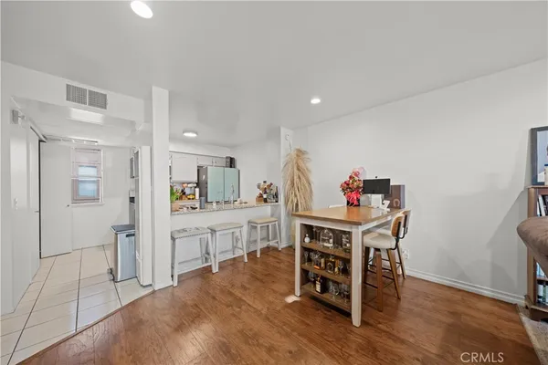 a kitchen with kitchen island granite countertop a sink a stove and refrigerator