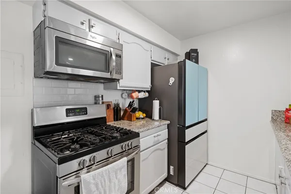 a kitchen with sink and mirror