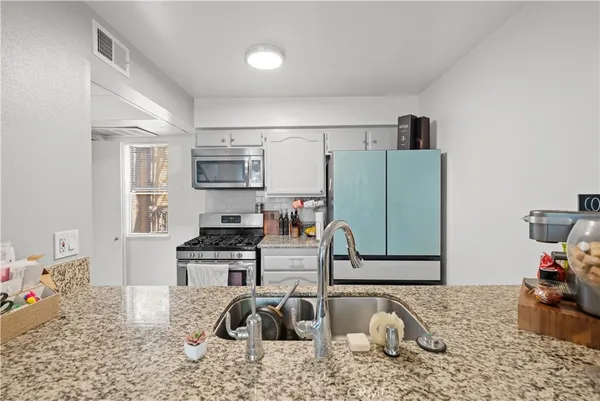 a stove top oven sitting inside of a kitchen