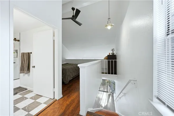 a view of hallway with furniture and wooden floor