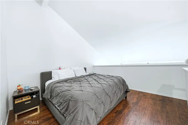 a bedroom with a bed and a night stand