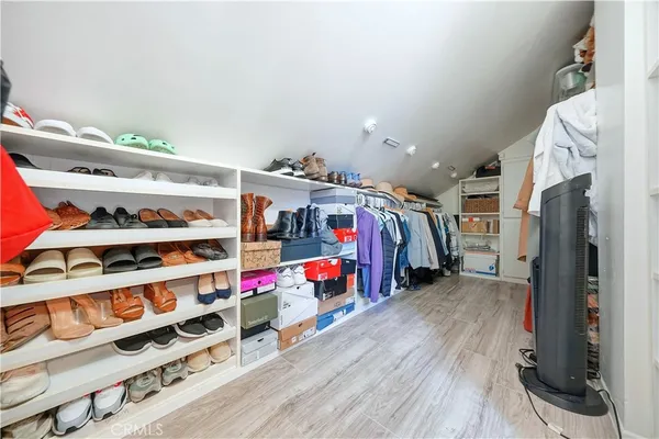 a storage room with washer and a fireplace