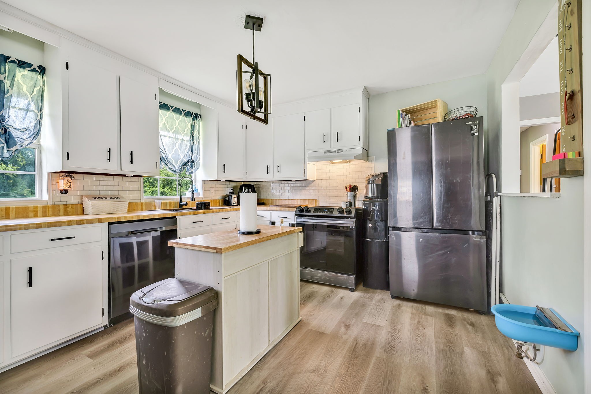 436 Youree Road Murfreesboro, TN 37127 - Photo 13 of 32 a kitchen with a refrigerator sink and white cabinets