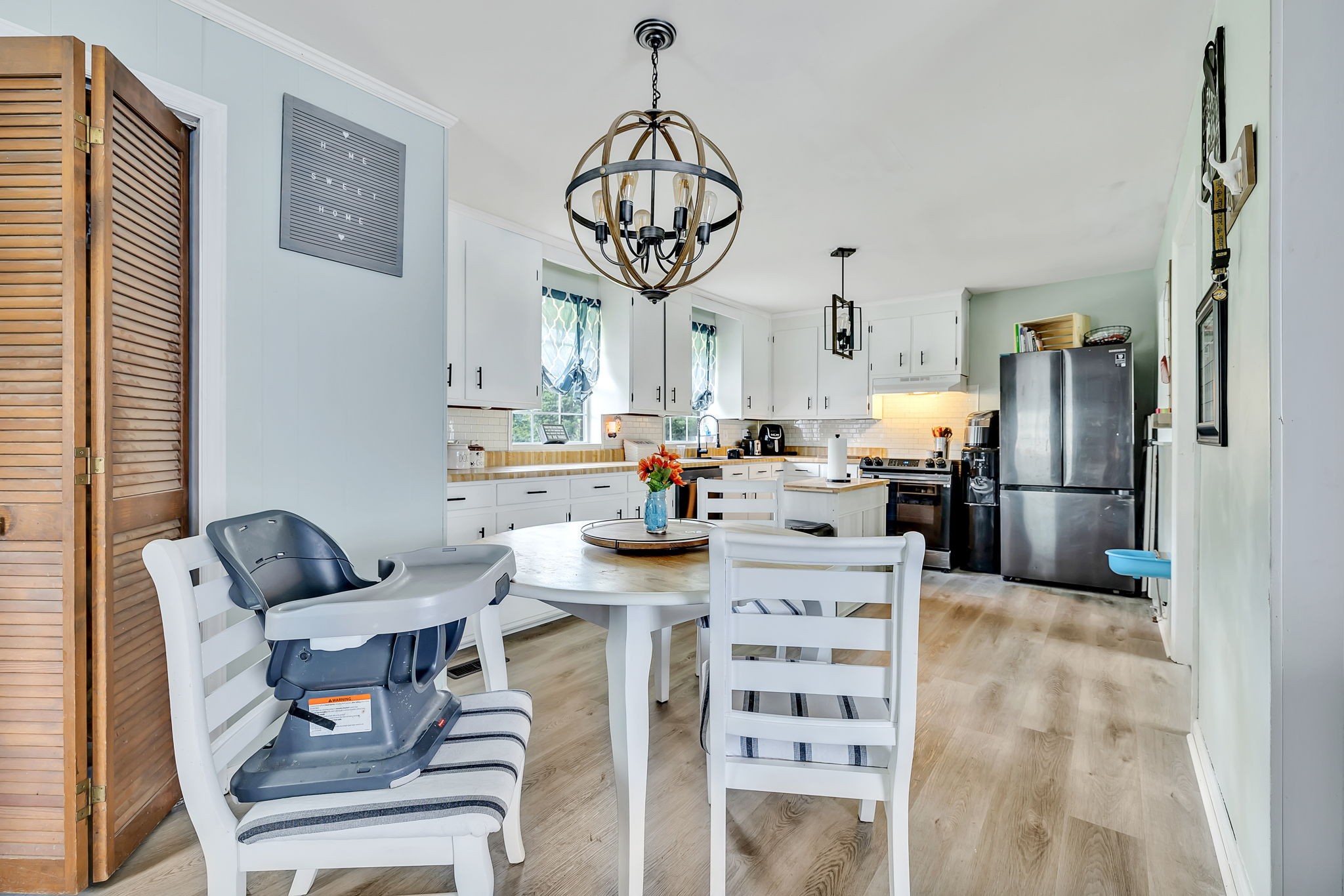 436 Youree Road Murfreesboro, TN 37127 - Photo 20 of 32 a kitchen with stainless steel appliances kitchen island granite countertop a refrigerator and a dining table