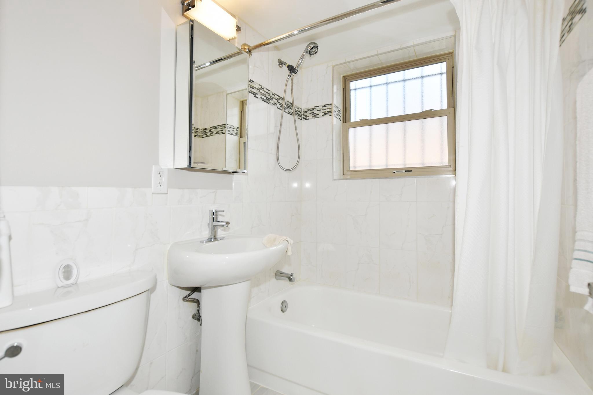 2900 Pomeroy Road Southeast, Unit 104 Washington, DC 20020 - Photo 15 of 19 a bathroom with a sink a toilet and a bathtub