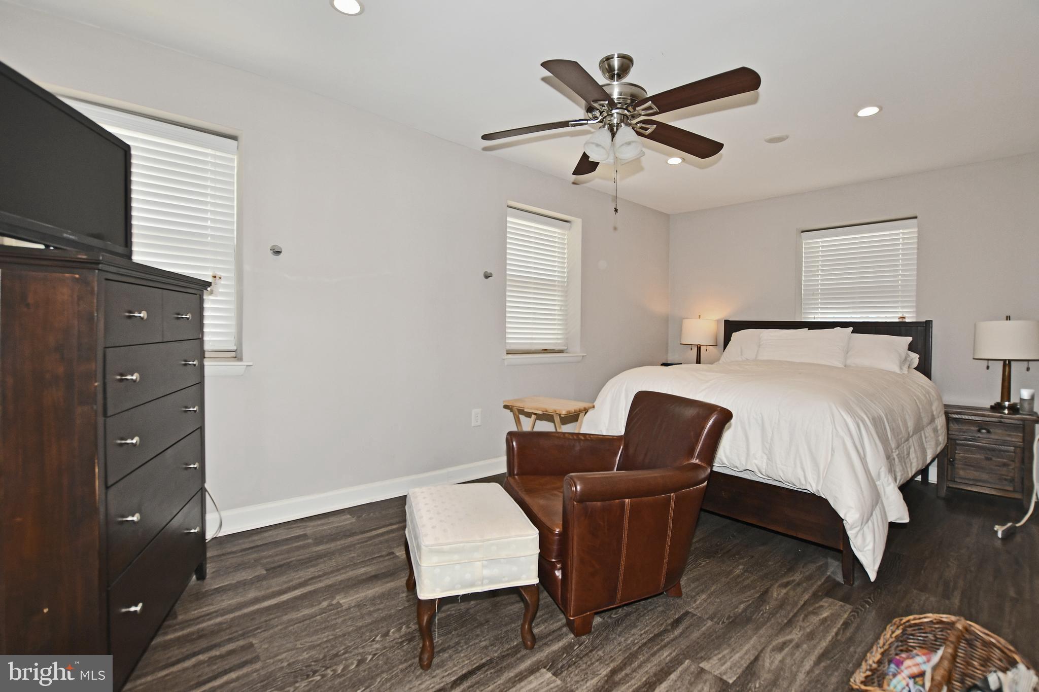 2900 Pomeroy Road Southeast, Unit 104 Washington, DC 20020 - Photo 16 of 19 a bedroom with a bed and wooden floor