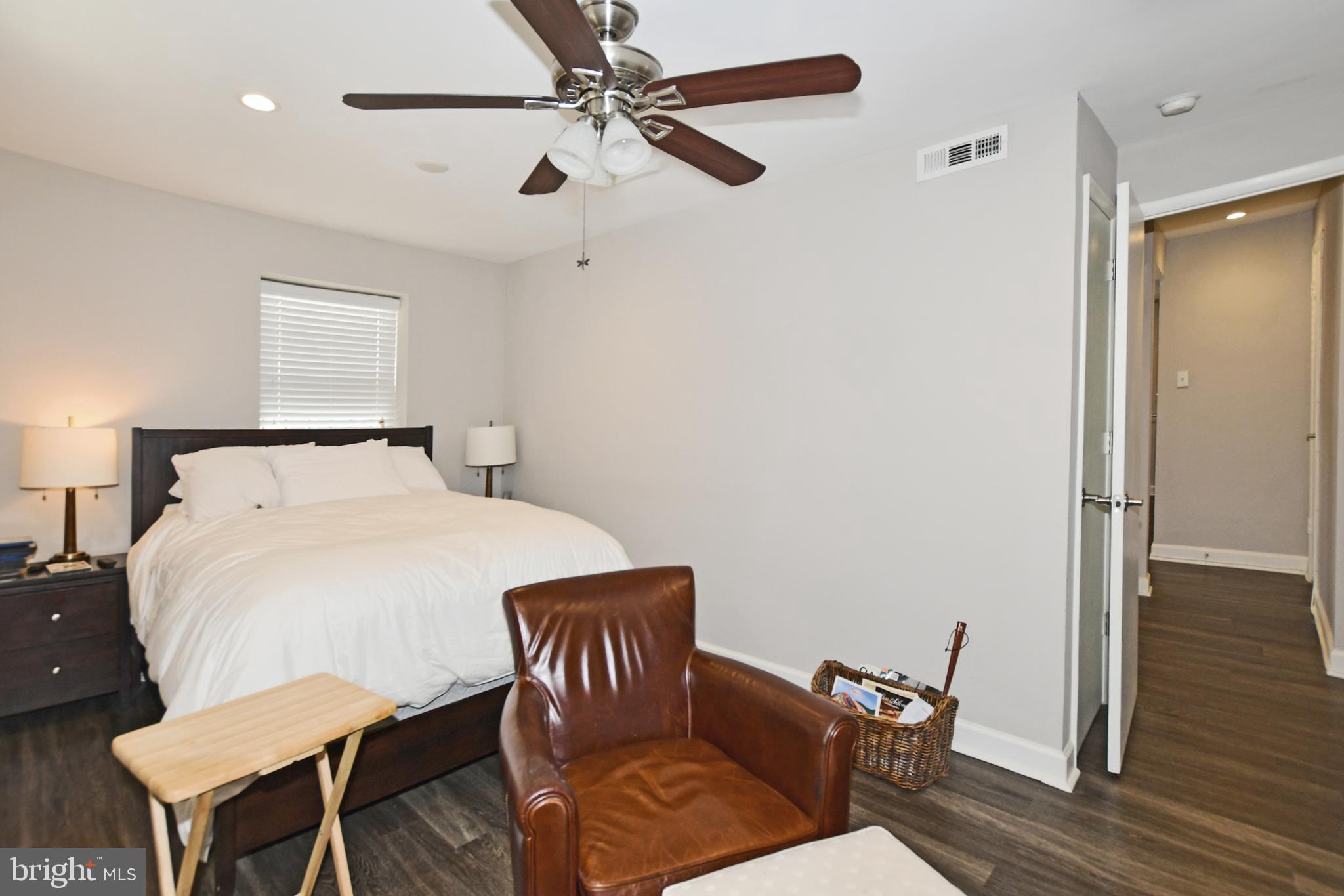 2900 Pomeroy Road Southeast, Unit 104 Washington, DC 20020 - Photo 18 of 19 a bedroom with a bed and wooden floor