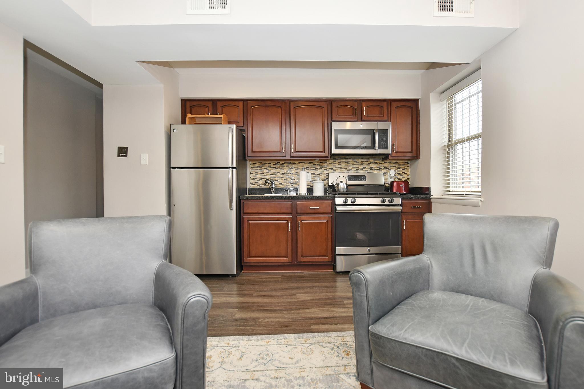 2900 Pomeroy Road Southeast, Unit 104 Washington, DC 20020 - Photo 4 of 19 a kitchen with stainless steel appliances granite countertop a refrigerator and a stove top oven