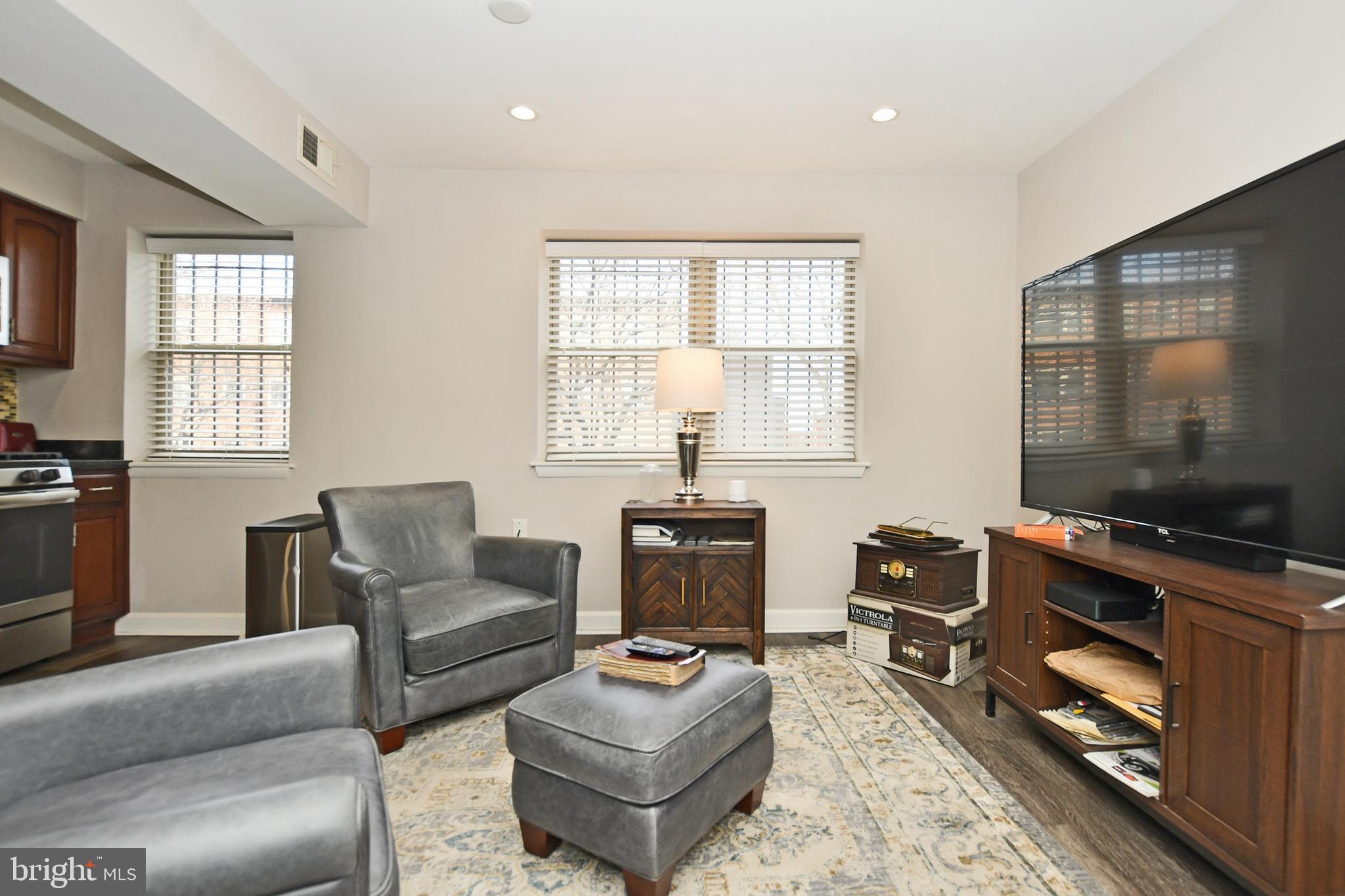 2900 Pomeroy Road Southeast, Unit 104 Washington, DC 20020 - Photo 5 of 19 a living room with furniture a flat screen tv and a window