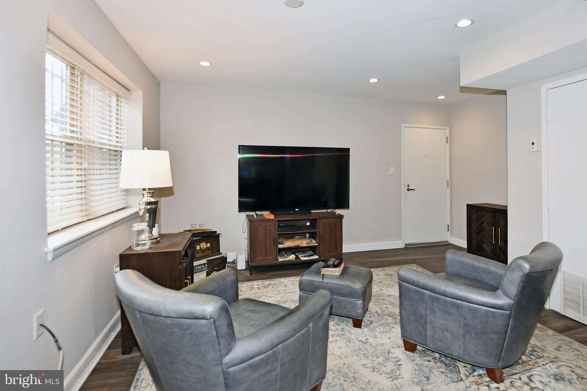 2900 Pomeroy Road Southeast, Unit 104 Washington, DC 20020 - Photo 7 of 19 a living room with furniture and a flat screen tv