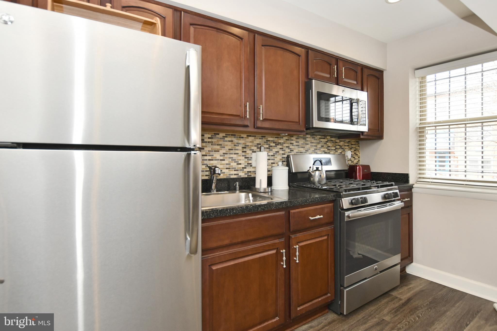2900 Pomeroy Road Southeast, Unit 104 Washington, DC 20020 - Photo 9 of 19 a white refrigerator freezer sitting inside of a kitchen