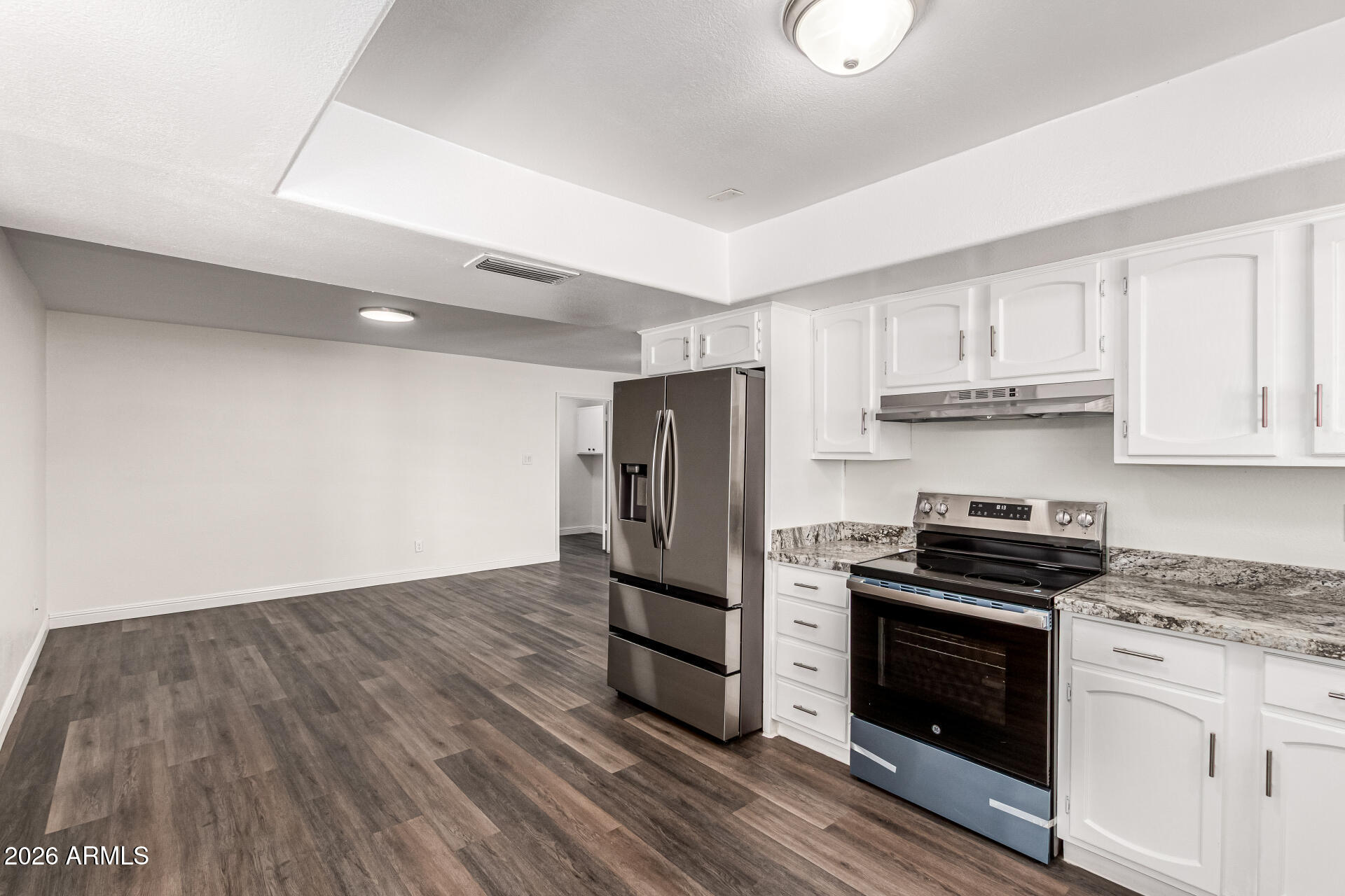 2540 West Roveen Avenue Phoenix, AZ 85029 - Photo 14 of 31 a kitchen with granite countertop a stove and a refrigerator
