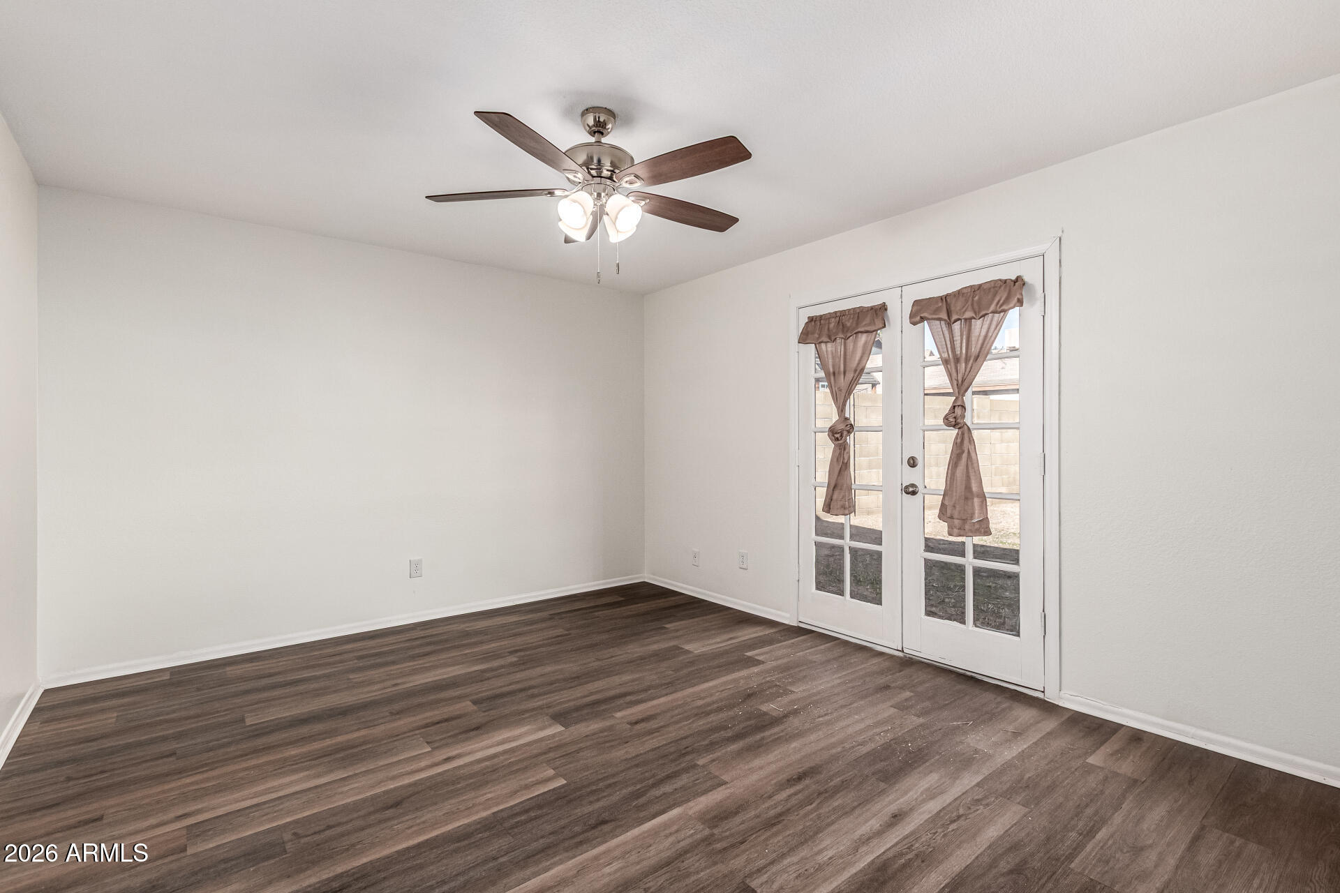 2540 West Roveen Avenue Phoenix, AZ 85029 - Photo 15 of 31 wooden floor in an empty room with a window