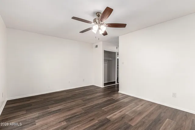 a view of an empty room with wooden floor