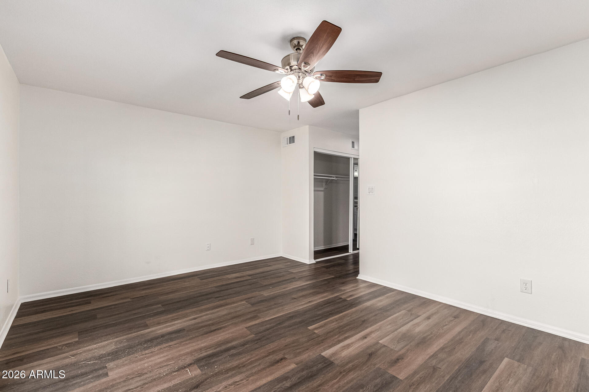 2540 West Roveen Avenue Phoenix, AZ 85029 - Photo 16 of 31 a view of an empty room with wooden floor