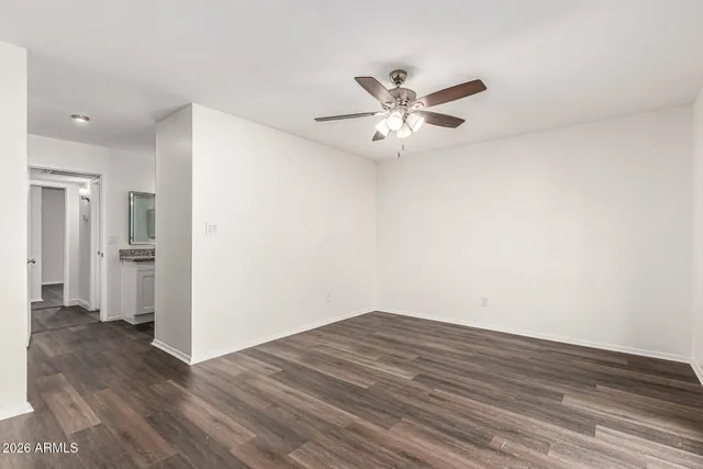a view of empty room with wooden floor