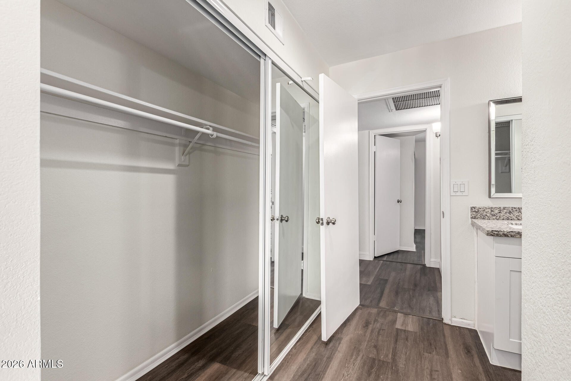 2540 West Roveen Avenue Phoenix, AZ 85029 - Photo 18 of 31 a view of a hallway with wooden floor