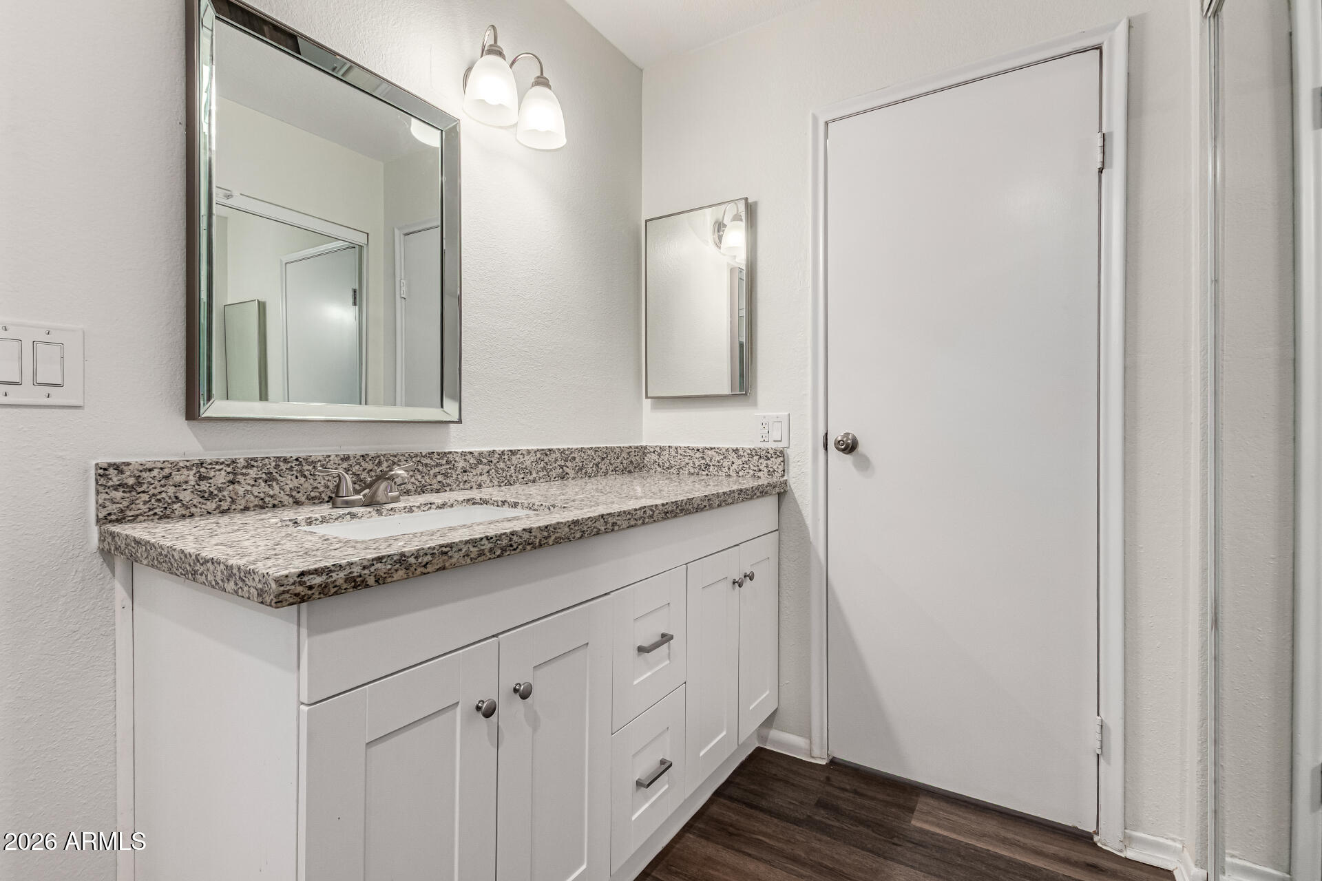 2540 West Roveen Avenue Phoenix, AZ 85029 - Photo 19 of 31 a bathroom with a granite countertop sink and a mirror