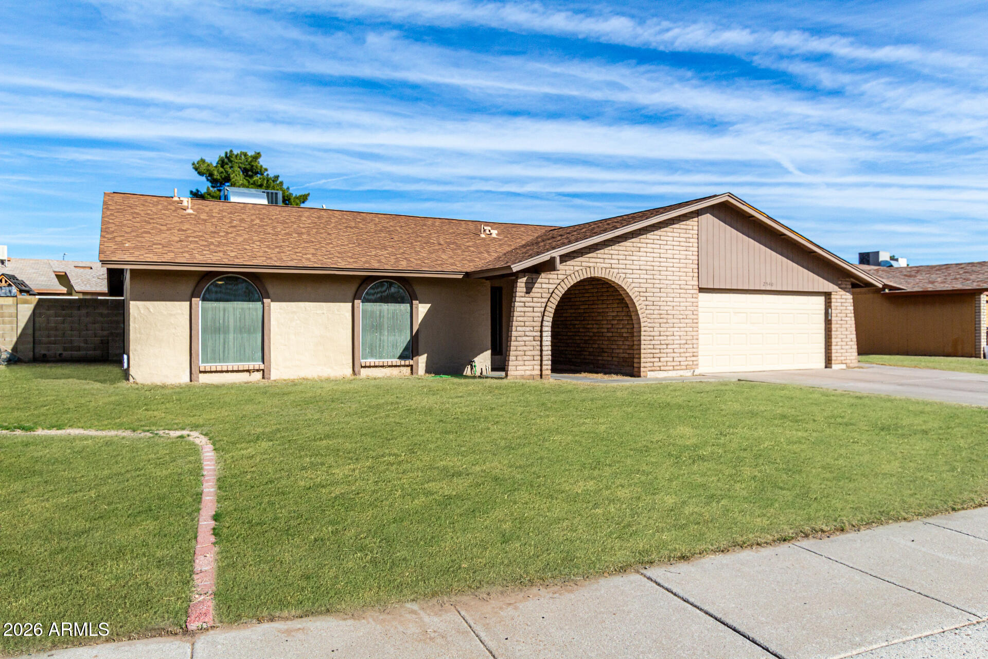 2540 West Roveen Avenue Phoenix, AZ 85029 - Photo 2 of 31 a front view of a house with a garden
