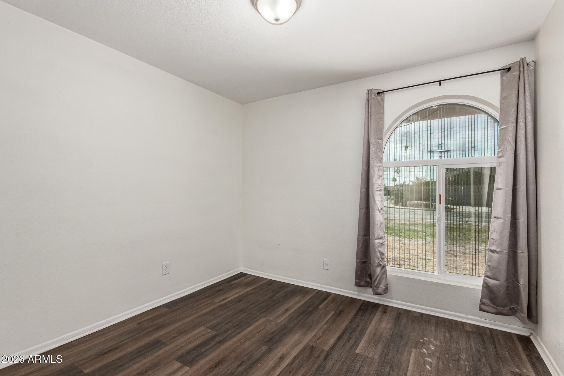 2540 West Roveen Avenue Phoenix, AZ 85029 - Photo 21 of 31 a view of empty room with wooden floor and fan