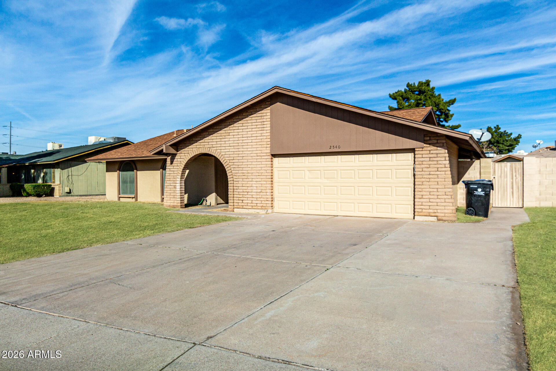 2540 West Roveen Avenue Phoenix, AZ 85029 - Photo 3 of 31 a view of a house with a yard and garage
