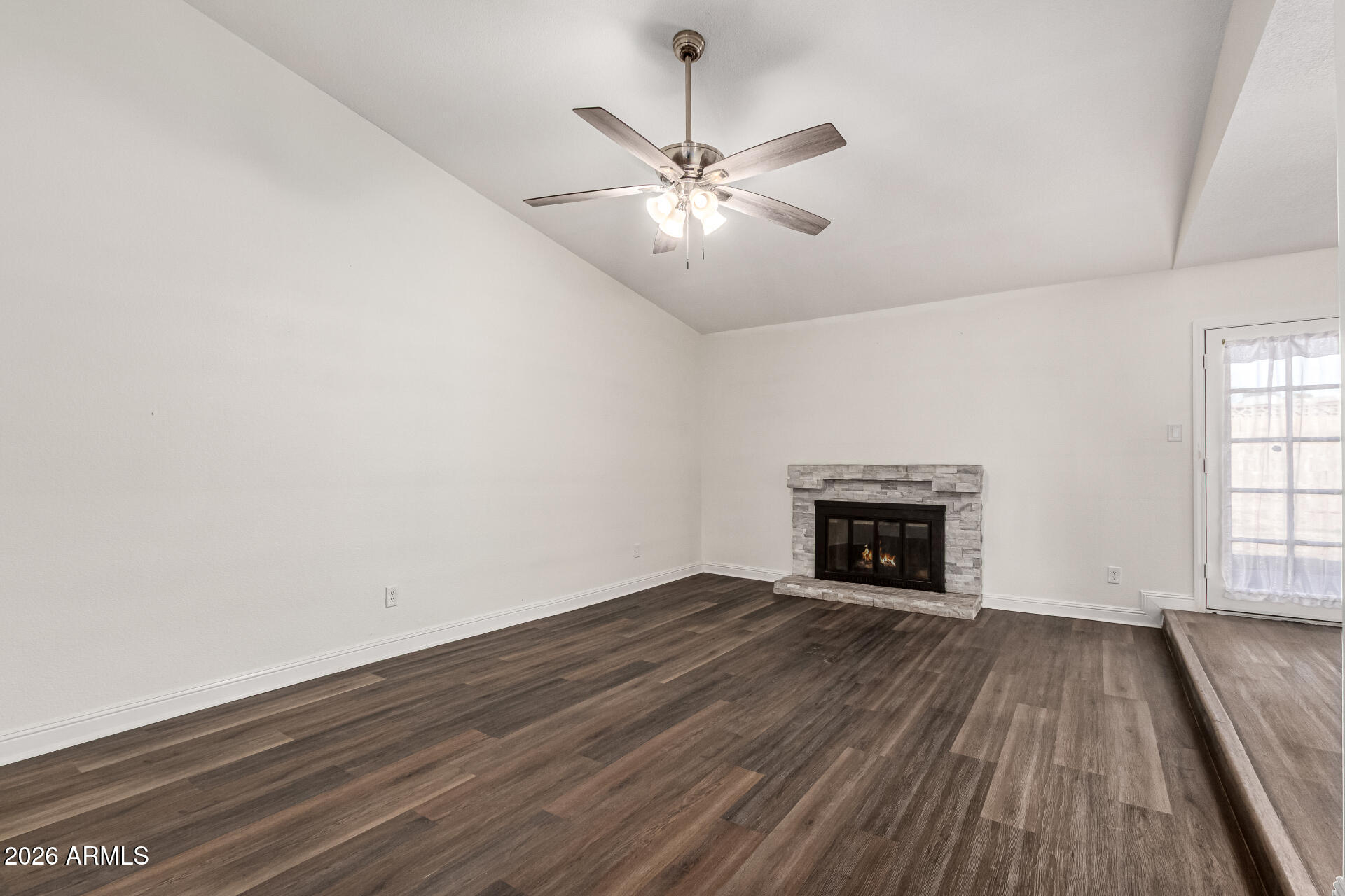 2540 West Roveen Avenue Phoenix, AZ 85029 - Photo 6 of 31 wooden floor in an empty room with a fireplace