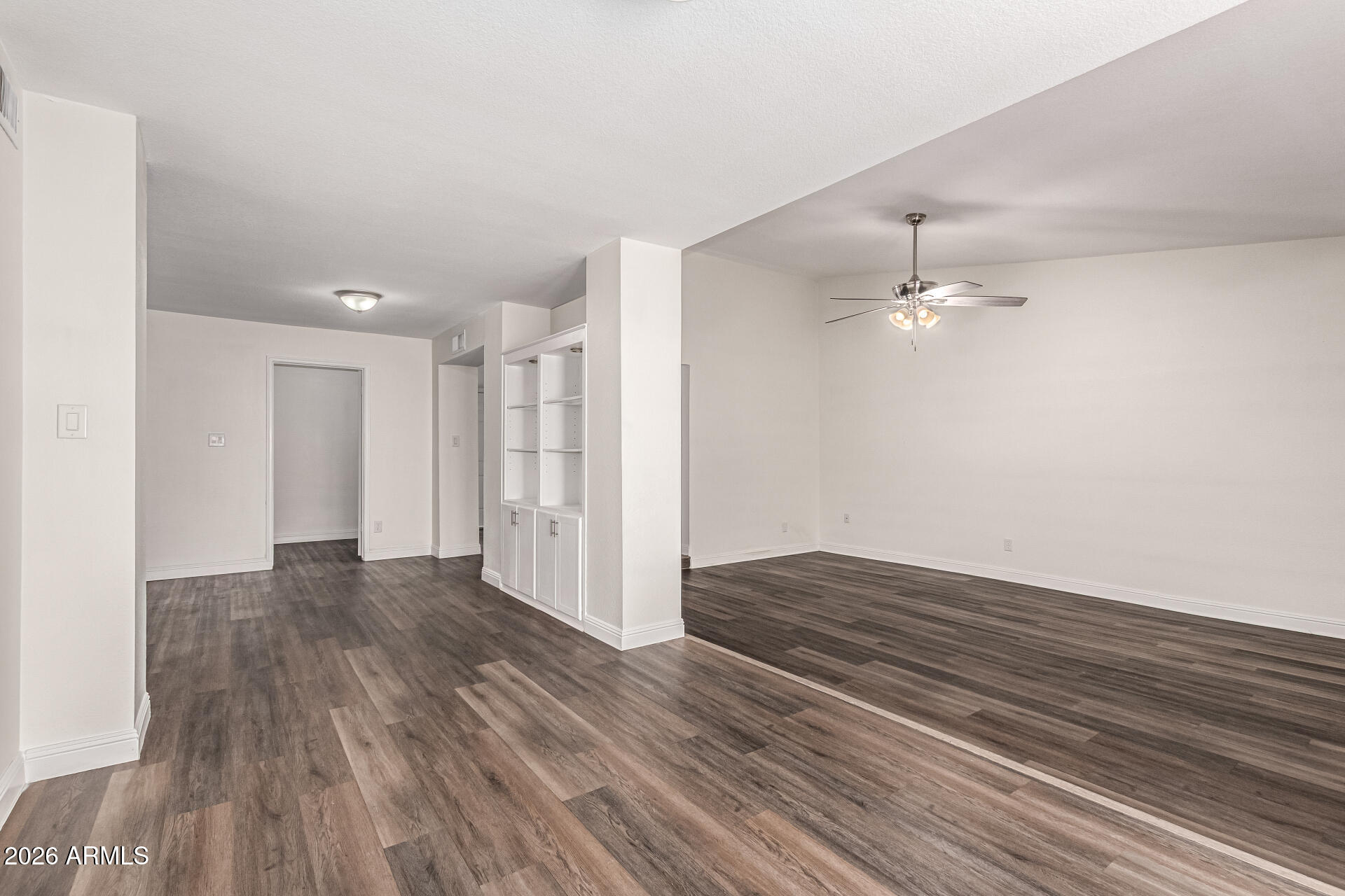 2540 West Roveen Avenue Phoenix, AZ 85029 - Photo 8 of 31 a view of an empty room with wooden floor