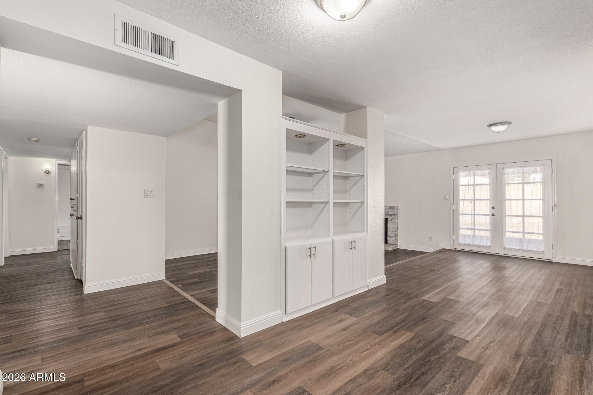 2540 West Roveen Avenue Phoenix, AZ 85029 - Photo 9 of 31 wooden floor in an empty room with a window