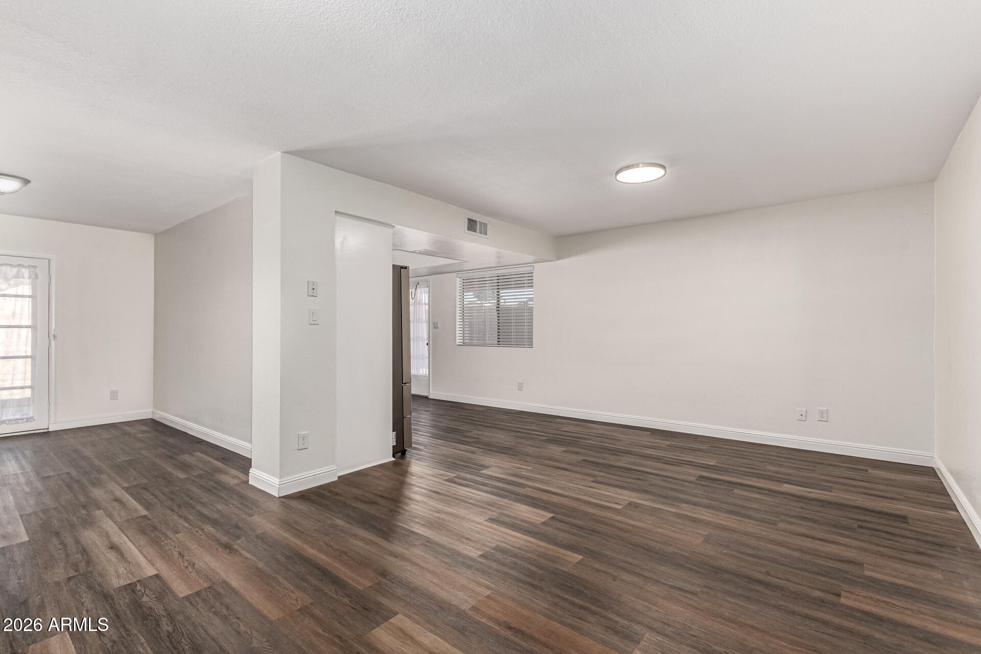 2540 West Roveen Avenue Phoenix, AZ 85029 - Photo 10 of 31 a view of an empty room with wooden floor