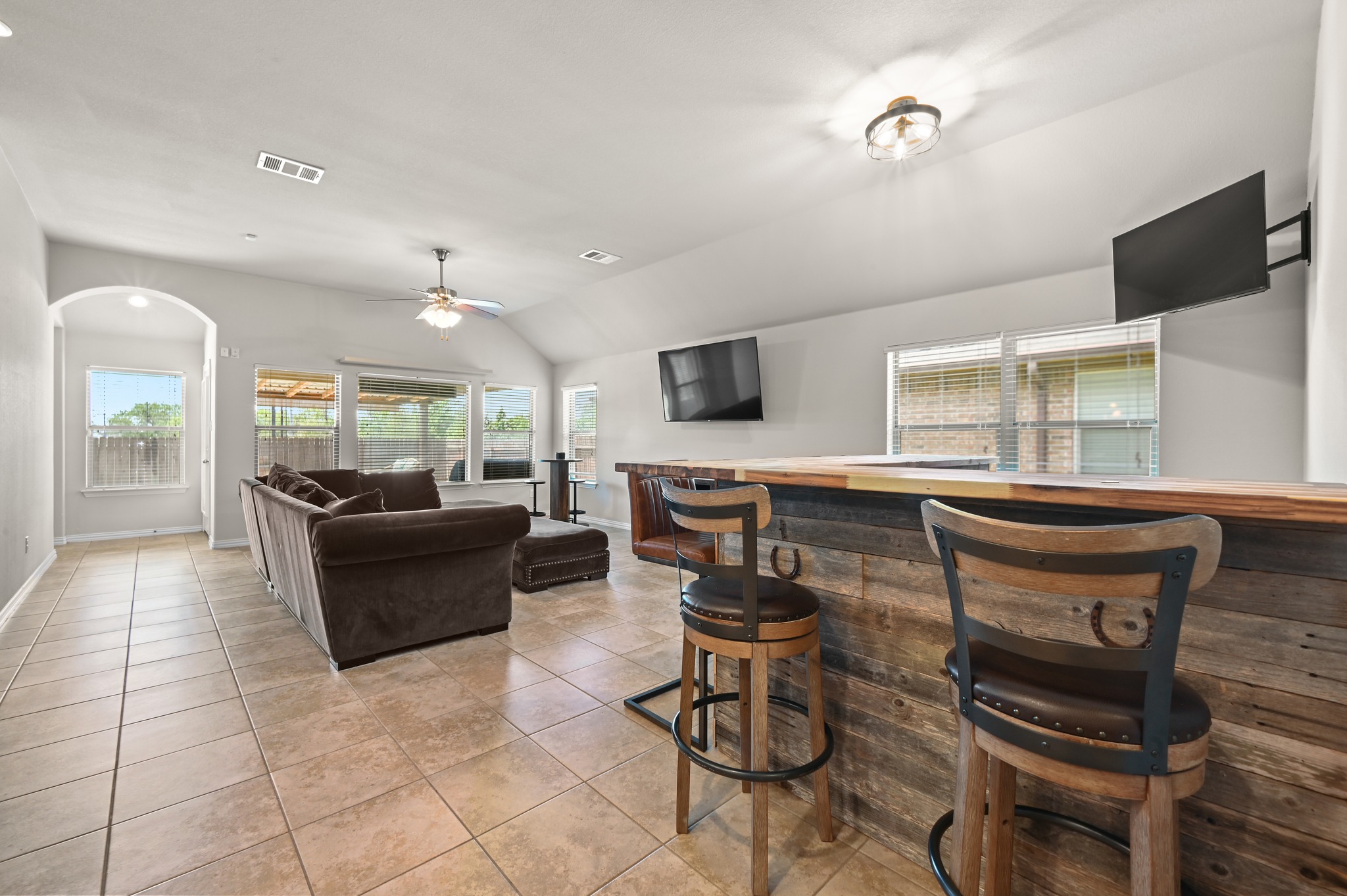 877 Hot Spring Valley Buda, TX 78610 - Photo 15 of 36 a living room with furniture a flat screen tv and large window