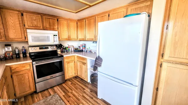 a kitchen with sink a microwave and cabinets