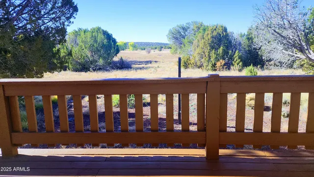 a view of a house with a wooden deck
