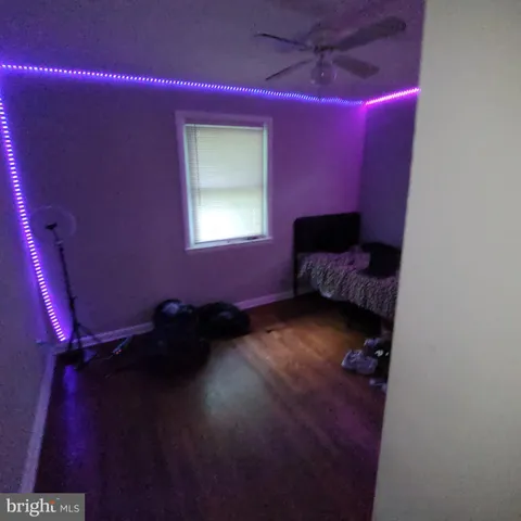 a bed room with a bed window and a chandelier