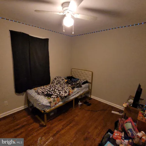 a room with wooden floor and pool table