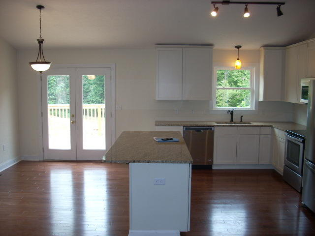 1071 Chandler Road Goodview, VA 24095 - Photo 5 of 17 a kitchen with a sink a window a counter top space and stainless steel appliances