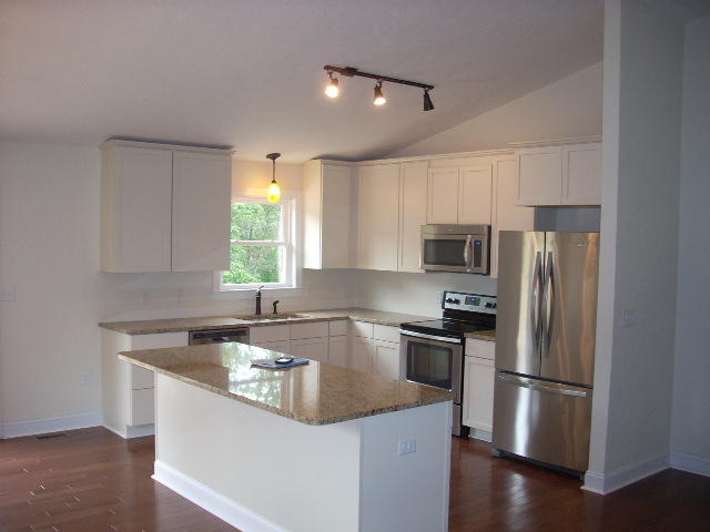 1071 Chandler Road Goodview, VA 24095 - Photo 6 of 17 a kitchen with a refrigerator a sink a window and stainless steel appliances