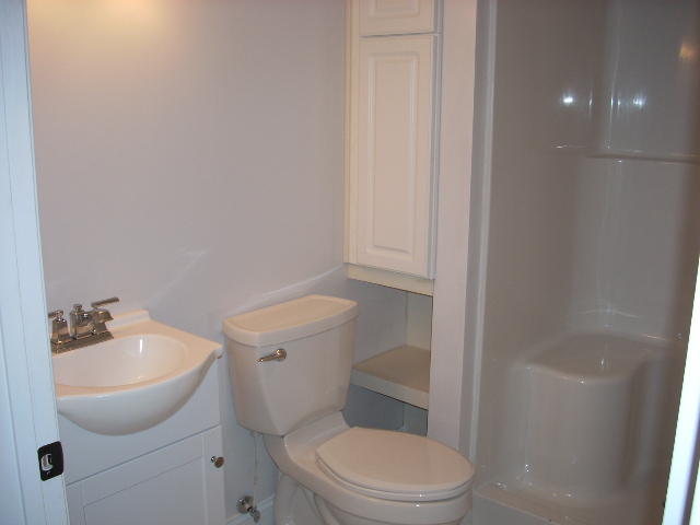 1071 Chandler Road Goodview, VA 24095 - Photo 9 of 17 a white toilet sitting next to a bathroom sink
