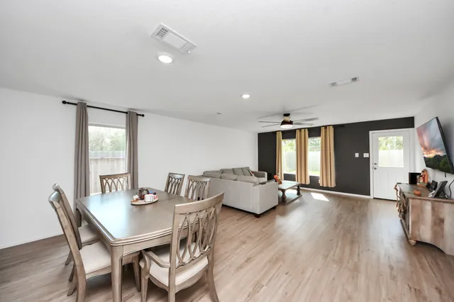 a view of a dining room with furniture and wooden floor