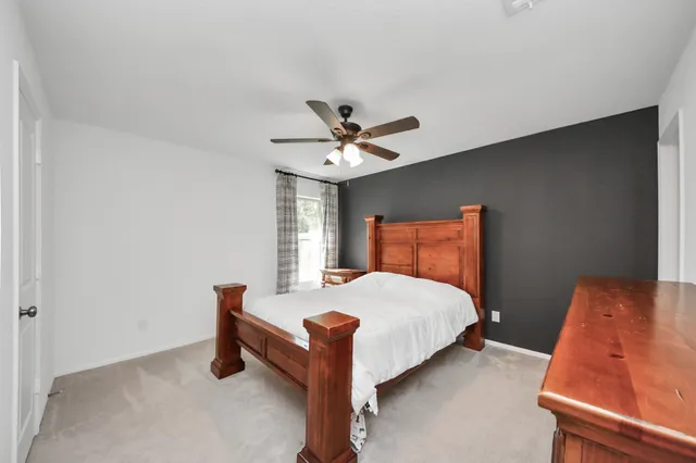 a bedroom with a bed and window