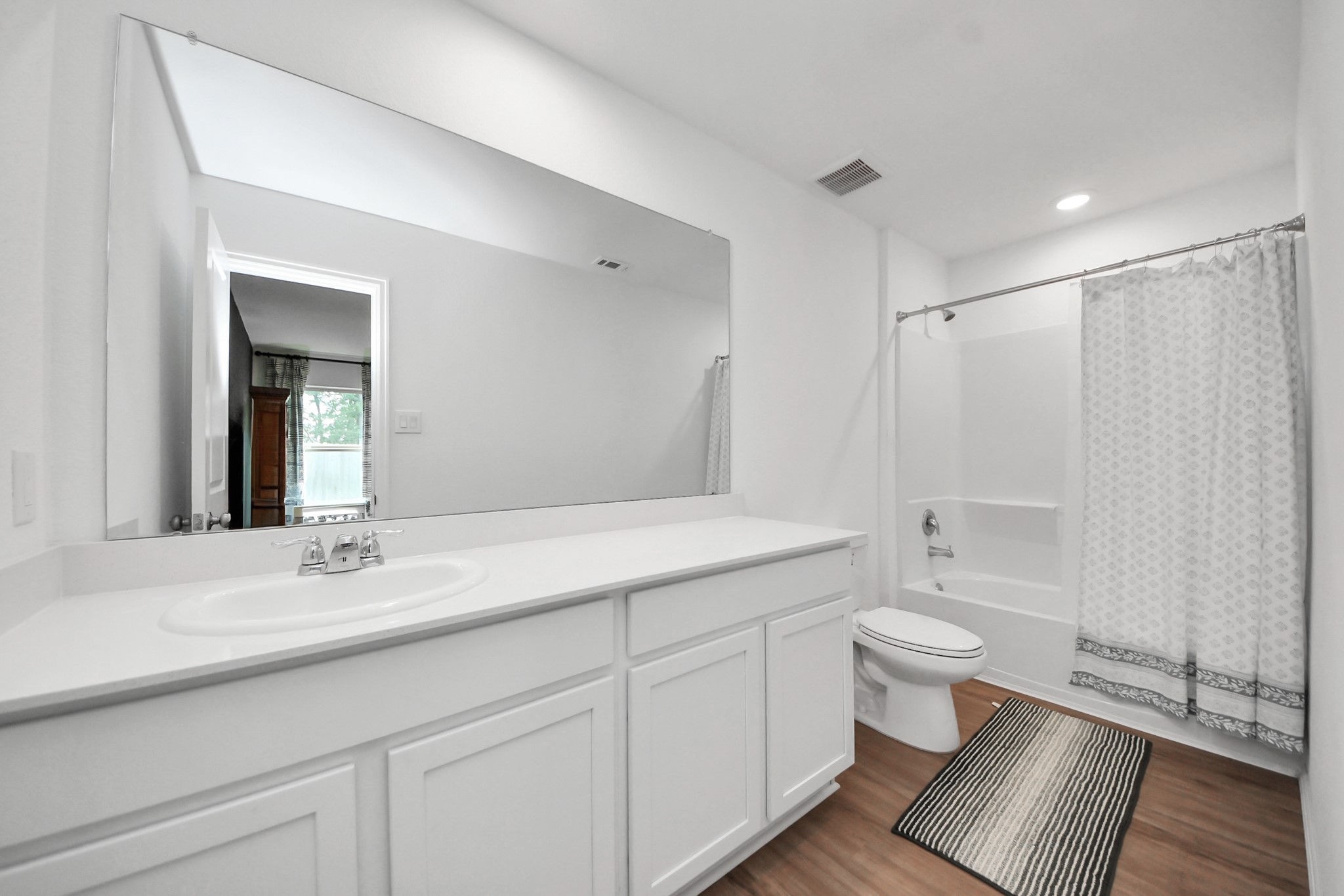 22828 Great Egret Drive Splendora, TX 77372 - Photo 15 of 39 a bathroom with a sink toilet a mirror and vanity